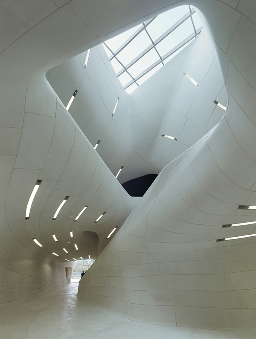 Louisiana State Museum & Sports Hall of Fame (Image by Trahan Architects) | Interior Stone Veneer with Complex Curves, Depiction of Cane River Channels with Monolithic Design | Large Size Custom Design Stone Panels | Products: Cast Stone, GFRC | DOWNLOAD CASE STUDY >>